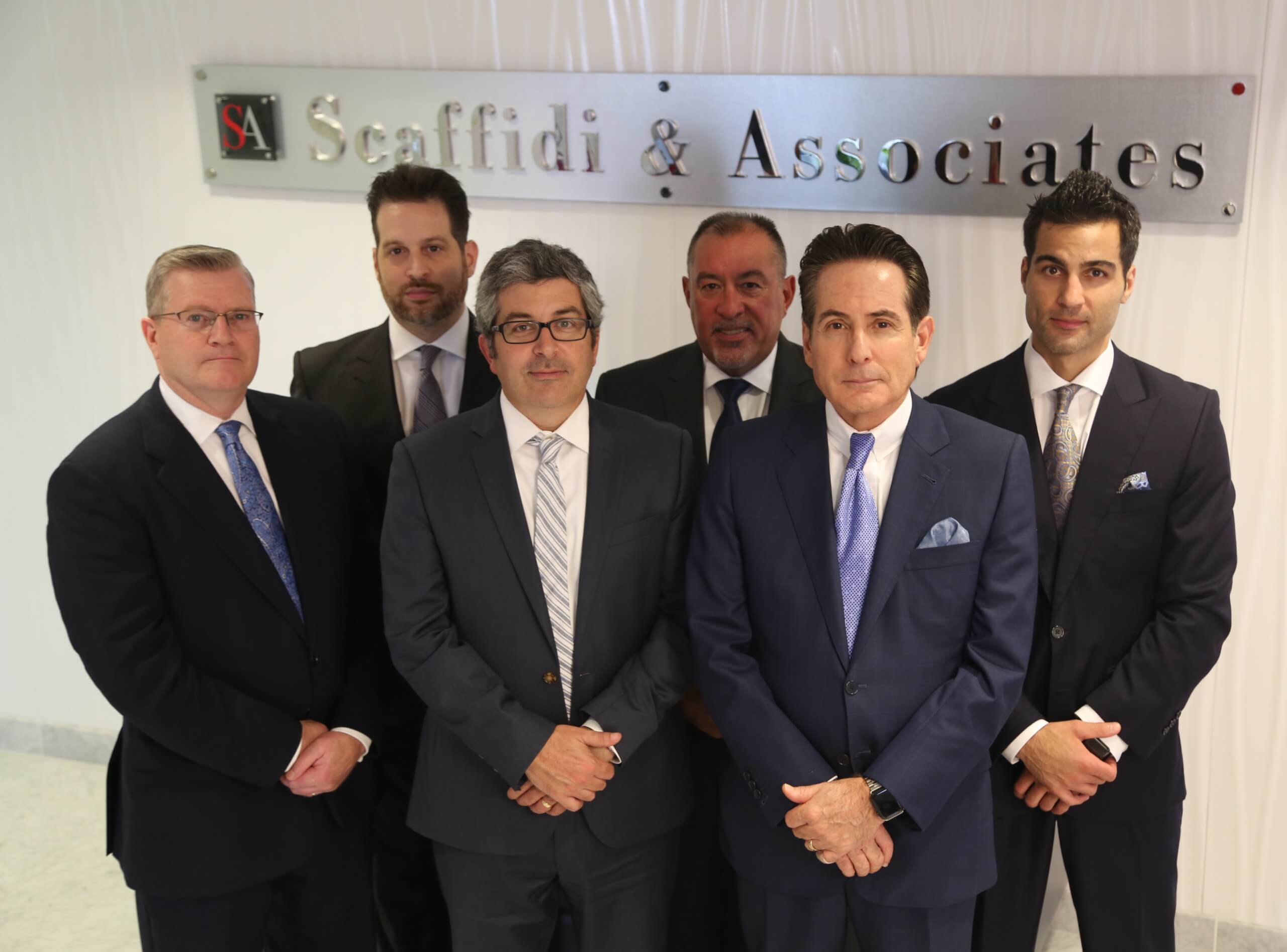 Roy Scaffidi and the trial attorneys at Scaffidi & Associates posing for a group photo in their New Your City law firm.